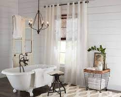 Vintage Chandelier Hanging Over A Clawfoot Bathtub Bathroom Hanging Lights Bathtub Lighting Bathroom Chandelier