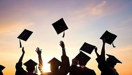 Graduation caps thrown in sky
