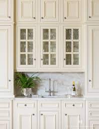Glass doors let the light shine into your space, illuminating your space, ceramics, and dishware displays. How To Make Your Kitchen Beautiful With Glass Cabinet Doors Heather Hungeling Design