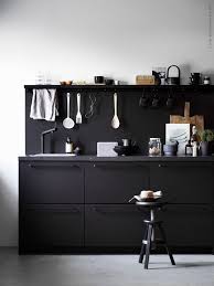 Check out how stylish this apartment designed by daniele petteno architecture the cabinetry contrasts with the crisp white walls and ceiling and the palette is completed by black marble countertop and backsplash surfaces. Ikea Black Kitchen Made From Recycled Material Kungsbacka Black Kitchens Black Kitchen Cabinets