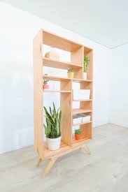 A funky bright wood bookcase with open shelves and drawers has plenty of storage space and adds color to the room. Diy Mid Century Modern Bookcase Modern Builds