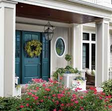 The warm sunny color of this house's exterior is the perfect background for neutral colored architectural elements like the beige garage door, gray stone posts and gray shingle roofing. Home Design Fresh Bold Paint Color For Front Door Is Quick Easy Exterior Door Colors Painted Front Doors Front Door Paint Colors