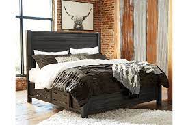 Handsome, hearty profile of this high headboard bed is made all the more interesting with planked faux barn door panels with metal hardware. Baylow Queen Panel Bed With 4 Storage Drawers Ashley Furniture Homestore