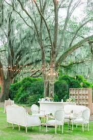 Outdoor Lounge With Chandelier And Cafe Lighting Dana Cubbage Weddings Charleston Sc Outdoor Cafe Cafe Lights Wedding Furniture