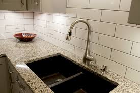 Grey and white kitchen features crisp white cabinets adorned with nickel hardware paired with gray countertops and a linear marble tiled backsplash. Grey Kitchen With White Subway Tile Backsplash And Granite Countertops Copley Transitional Kitchen Cleveland By Cabinet S Top Houzz