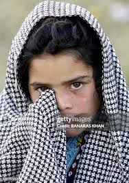 A grieved Kashmiri mother Nasreen Bibi sits under a collapsed roof of...  News Photo