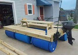 Classic wooden boat plans is a collection of established wooden boat designs ranging from the other plans include chris craft, hacker, gar wood, riva, switzer, barrel back, baby bootlegger. A Boat Made Of Wood And 55 Gallon Poly Drums Woodworking Plans Beginner Beginner Woodworking Projects Floating Picnic Table