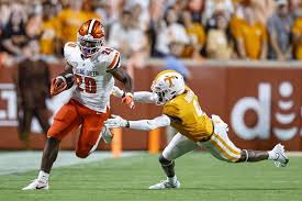 Bowling Green running back Jamal Johnson (20) gets past Tennessee defensive  back Warren Burrell (4) during the first half of an NCAA college football  game Thursday, Sept. 2, 2021, in Knoxville, Tenn. (