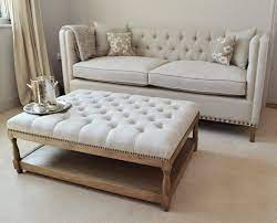 Our upholstered coffee tables come in a variety of shapes, styles and materials, perfect for any living room. Rustic Upholstered Coffee Table And White Chesterfield Sofa With Colorful Pillo Upholstered Ottoman Coffee Table Ottoman Coffee Table Upholstered Coffee Tables