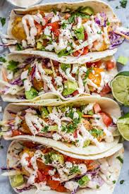 Tender and flaky fish full of spicy flavor tucked into flour tortillas and topped with garlic cilantro lime slaw. Pin On Yum Fishy Fishy
