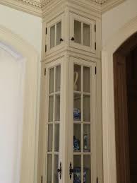 Curio Cabinet A Tall And Skinny Cabinet With Glass Doors And Panels That Is Used To Display Items Corner China Cabinets Corner Kitchen Cabinet Corner Cabinet