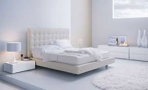 Elegant modern primary bedroom design in browns this is a close look at the modern bedroom that has a white bed that blends with the white walls and white ceiling. Moving Company Quotes Tips To Plan Your Move Mymove White Furniture Bedroom Modern White Bedroom Set Furniture White Bedroom Furniture For Adults