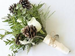Blair held a winter bouquet filled with brown pinecones and evergreen plants, all of which was frosted on top. Winter Wedding Bouquets With Pine Cones Off 79 Buy