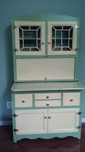The upper portion features two doors with stenciled glass fronts above a storage space with tambour door and a baked white enamel over steel work surface. Rare Vintage Hoosier Cabinet Apartment Size Kitchen Cupboard Bilt Well Furniture Antique Price Guide Details Page