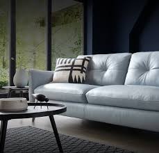 Grey master bedroom boasts silver grayw alls lined with white tufted headboard on queen bed dressed in white and gray ribbon bedding and white and gray monogram shams layered over gray shams beside a mirrored nightstand topped with cream. Inspirational Living Room Ideas Living Room Design Grey Chesterfield Sofa Living Room Ideas