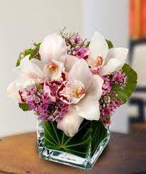 Lovely Orchids For Valentine S Day If Your Idea Of The Perfect Floral Arrangement Is Something Both Orchid Arrangements Orchid Centerpieces Flower Arrangements