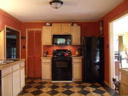 Red Kitchen With Maple Cabinets Black Marble Countertops And Painted Pine Checkerboard F Kitchen Redecorating Black Marble Countertops Maple Kitchen Cabinets