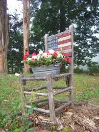 Old Primitive Chair Doubles As An American Themed Planter Nothing Hardly Is Trash For Me I Lined The Bottom Of This Old R Garden Garden Decor Garden Chairs