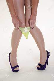 Woman Pulling Yellow Panties Over Her Knees Stock Photo, Picture And  Royalty Free Image. Image 22578563.