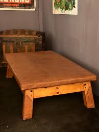 There is one large coffee table that has a pine wood top on it, and four sectionals that go beneath it with a leather top. Extra Large Leather Coffee Table Previously Used For Gymnastics