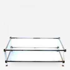 Its legs mirror the shape of the tempered glass top creating a sturdy and industrial design. Pierre Vandel A French Pierre Vandel Nickel Lucite And Glass Coffee Table