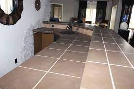 White wall cabinets and butcher block countertops keep things balanced. How To Paint Tile Countertops Before And After Love Our Real Life