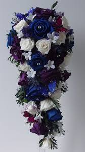 You can use them in place of ornamental grasses as well. Cascade Bridal Bouquet Made With Preserved Royal Blue Purple And White Roses Minus Th Purple Bridal Bouquet Purple Wedding Bouquets Cascading Wedding Bouquets