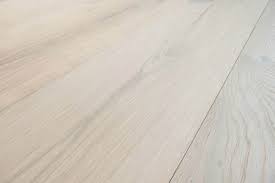 Bleached red oak stair rails, baseboards and treads complement the light shades of this staircase and room. Engineered Bleached Oak Flooring Italian 2 Ply Wide Plank