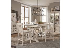 This set features a simple rectangular table on long sturdy legs with two backless counter height stools with padded, black pu seat covers. Magnussen Home Bronwyn 5 Piece Farmhouse Counter Height Dining Table Set With Bar Stools Value City Furniture Pub Table And Stool Sets