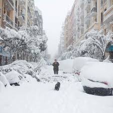 People walk through snow in central madrid. At Least Three People Die In Spain S Worst Snowstorm In 50 Years World News The Guardian