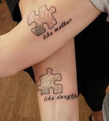Matching mother and daughter tattoos consisting of a feather. 66 Mother Daughter Tattoos That Show Their Unbreakable Bond Bored Panda