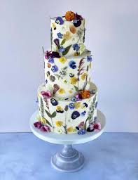 Used wisely, flowers can make a plain cake look spectacular. Pressed Flower Meadow Cake Weddings
