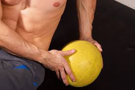 Sit down on the ground with your knees bent, heels firmly planted and your back about 45 degrees from the ground (a basic beginning sit up position). Medicine Ball Exercises For Abs Coach