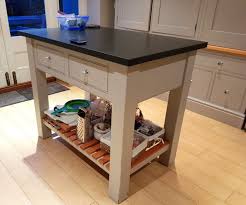 The kitchen pantry storage item features a spacious drawer and hidden storage behind two raised panel doors. Used Bespoke Painted Free Standing Kitchen With Island Dressers And Granite Worktops The Used Kitchen Company