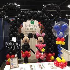 Helmet silhouette theme table decor: Mickey And Minnie Mouse Sculptures And A Giant Mouse Ear Balloon Arch Balloons By Tommy Minnie Mouse Balloons Birthday Balloon Decorations Mickey Balloons