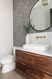 If storage is limited in the powder room, choose a vanity with open shelves or drawers. Walnut Floating Vanity This Stunning Powder Room Features A Custom Floating Walnut Vanity With Carrara Ma Powder Room Vanity Floating Vanity Powder Room Design