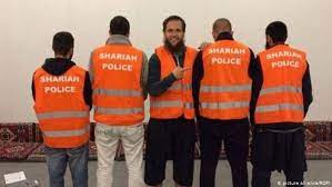 At the time of the sharia police patrol, the men were led by fundamentalist preacher sven lau who in 2017 was jailed in september 2014, the seven patrolled the streets of wuppertal, a west german. German Shariah Police Retrial Starts In Wuppertal News Dw 20 05 2019