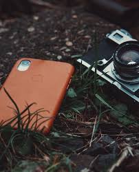 Enjoy and share your favorite beautiful hd wallpapers and background images. Hd Wallpaper Red Iphone And Gray Film Camera On Grasses Closeup Photography Wallpaper Flare