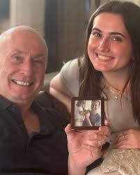 My brother Doug and Mary Calvert look at the picture they are holding