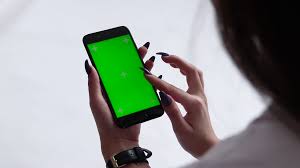 4k close up shot of head and hand of boy holding his smartphone with green screen and looking on it. Beautiful Girl Holding A Smartphone In The Hands Of A Green Screen Green Screen Hand Of Man Holding Mobile Smart Phone With Chroma Key Green Screen On White Background Stock Video Footage