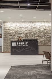 Spirit Realty Capital Offices Dallas Office Snapshots Modern Reception Desk Realty Real Estate Logo Design