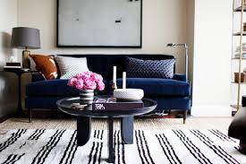 Blue couch black and white rug. Chic Midcentury Modern Living Area Features Navy Sofa Striped Rug Hgtv