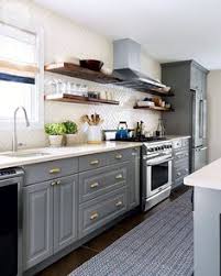 It features two adjoining walls that hold all the countertops, cabinets, and kitchen services, with the other two adjoining walls open. Home And Garden Design New Kitchen Design Images