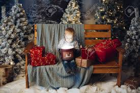 Maybe you would like to learn more about one of these? Smiling Lovely Baby D Sitting On Bench With Lots Of Christmas Presents Stock Photo Picture And Royalty Free Image Image 112974886