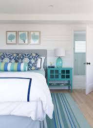An enjoyable bedroom with a navy and grey part separated with a large weathered wood roof over the bed, grey bedding and creamy furniture. Heather Gray Headboard With Turquoise Nightstand Cottage Bedroom