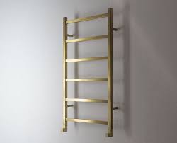 The reina serpe designer towel rail has a stunning design, it has modern square bars that flow and create a serpent like effect. Brushed Gold Ladder Towel Rail Gold Towel Warmers Livinghouse