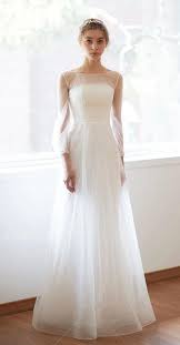 It cuts across the torso diagonally from one shoulder to under the other arm. Simple A Line Long Sleeves Wedding Dress Minimalistic Mesh Straight Cross Illusion Sheer Lace Gown Wedding Dresses Sheer Sleeves Wedding Dress Long Sleeve Wedding Dress Necklines