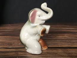 High Gloss Porcelain Elephant Sitting Trunk Up With Pink Ears Made In Japan Trunk Up Elephant High Gloss Nippon porcelain refers to vases, teapots, wall plaques, humidors, and other ceramic objects stamped nippon is an english word approximating a pronunciation of the japanese word for japan, but in 1921, the word was.continue reading.