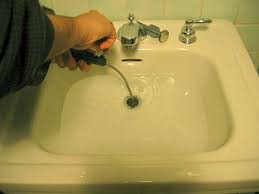using a hand held auger to unclog a sink