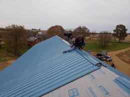 Though it is true that it is simpler to install a ridge vent before shingling, it is possible to retrofit one onto an already shingled roof. Metal Roofing Metal Roof On New Construction House In Rock City Il Metal Ridge Vent Being Installed